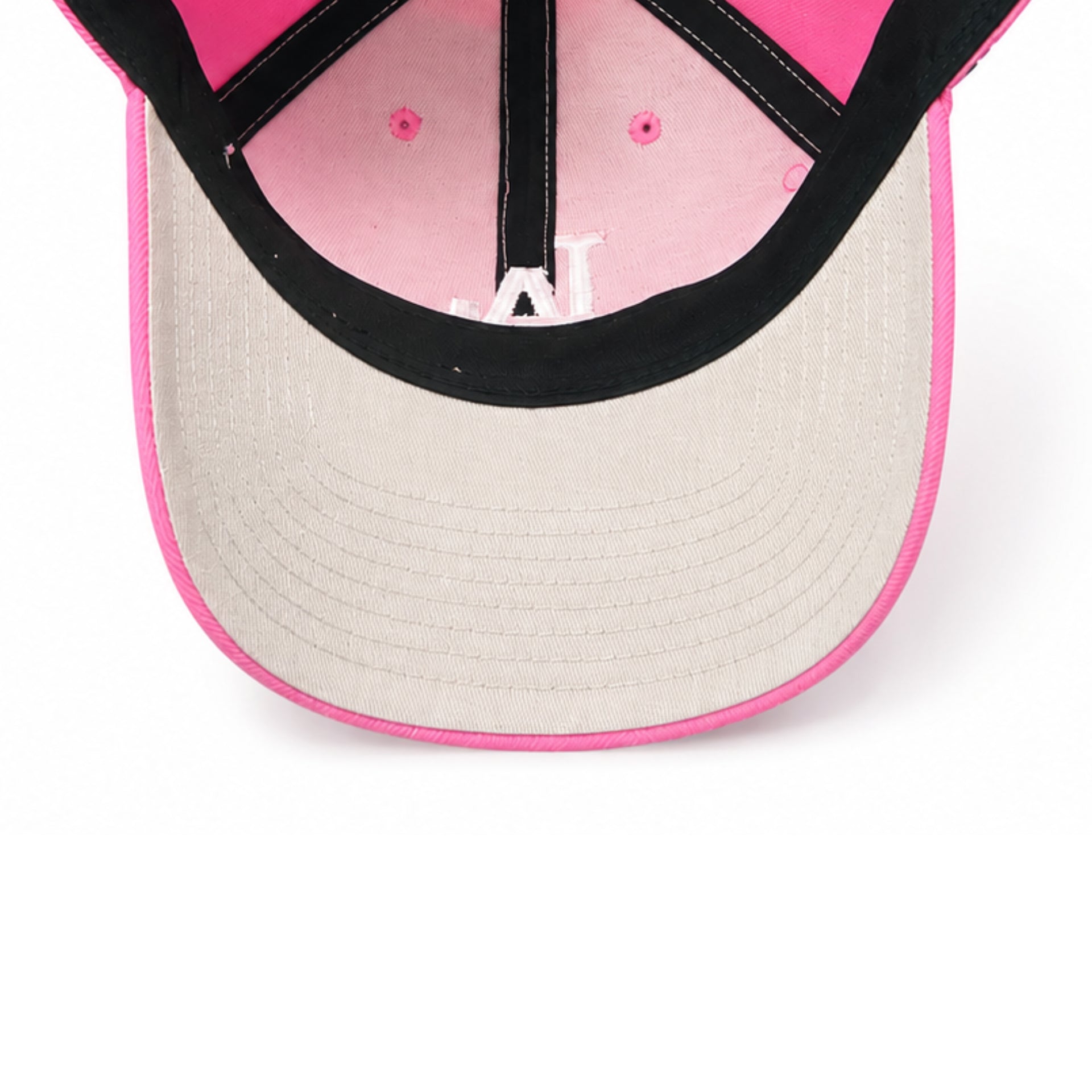 Close-up of a pink and beige cap with a black interior on a white background