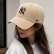 Woman wearing a '47 Brand New York Yankees Khaki MVP Adjustable Hat with navy NY logo and curved brim