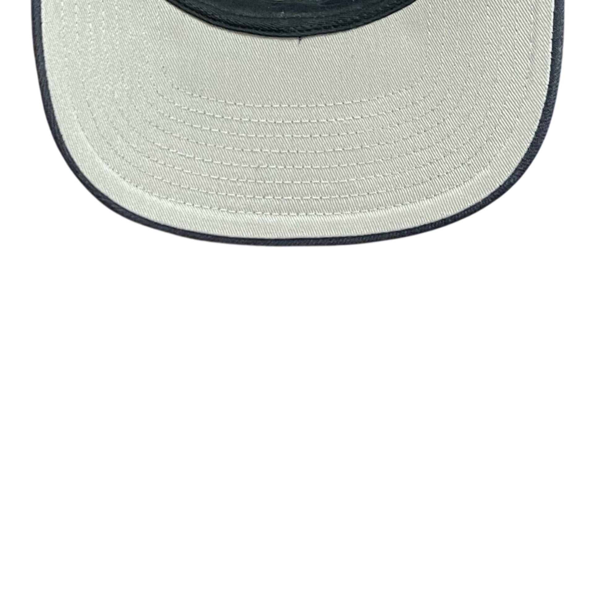 Close-up of a straw hat with a navy rim on a white background