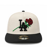 Cap with 'LA' logo and roses on a white background