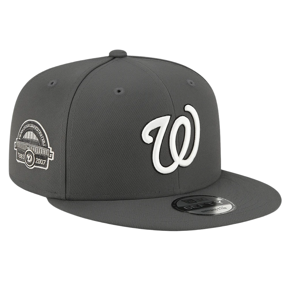 Graphite gray Washington Nationals New Era 9FIFTY snapback cap featuring a white embroidered "W" logo on the front and a commemorative RFK Stadium side patch, displayed on a white background.