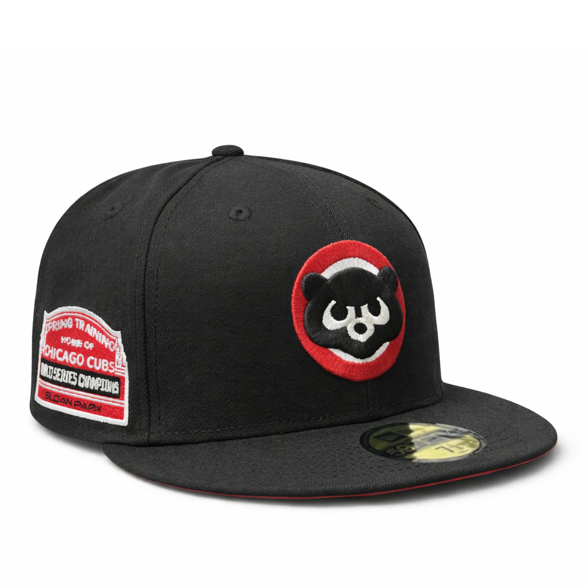 Black baseball cap with a chicago cubs baseball team cooperstown logo and spring training world baseball champion side patch on a white background