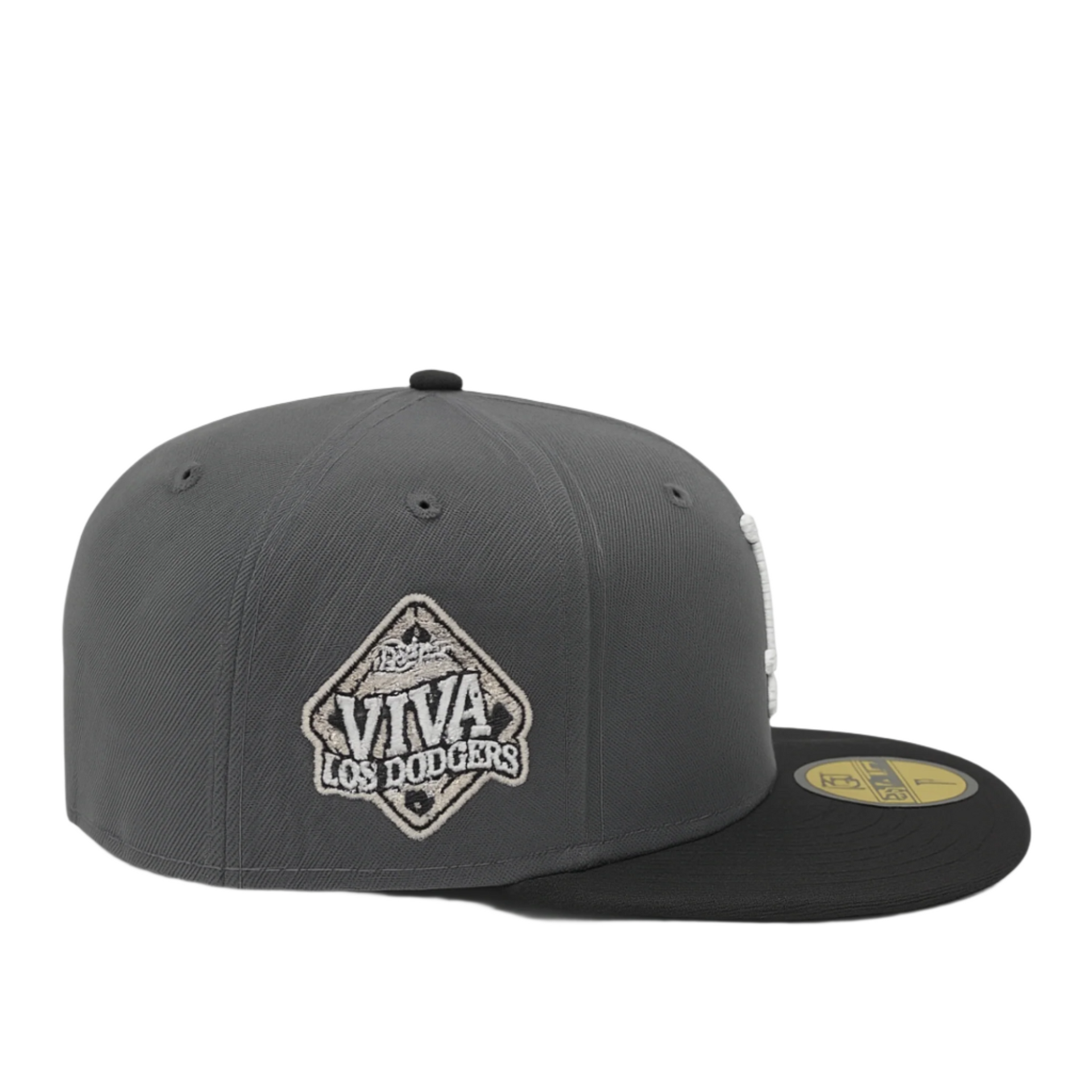 Side view of a graphite and black New Era 59FIFTY fitted cap featuring a white and gray embroidered 'Viva Los Dodgers' patch and a gold size sticker on the flat black brim, displayed against a white background.