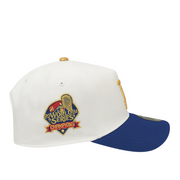 Side view of a New Era 9FORTY A-Frame cap with a white crown and royal blue brim, featuring a 2024 World Series Champions patch embroidered in red, gold, and navy on the side panel.