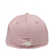 Back view of a pastel pink New Era fitted cap featuring an embroidered MLB logo in soft mint and white, displayed against a white background.