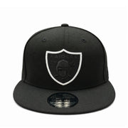 Black cap with a black raiders logo and white outline on a white background