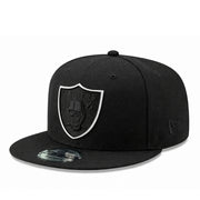 side view of Black cap with a black raiders logo and white outline on a white background