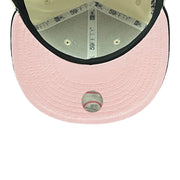 Pink baseball cap with a baseball on a white background
