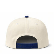 Back view of a beige cap with blue accents on a white background