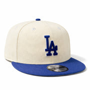 Beige and blue baseball cap with LA logo on a white background