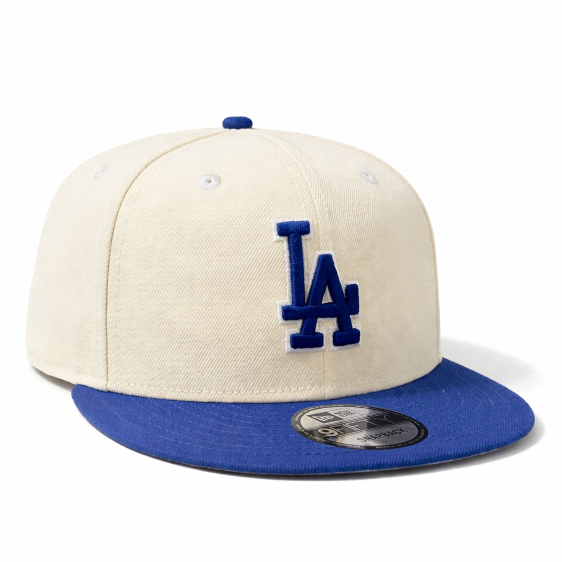 Beige and blue baseball cap with LA logo on a white background