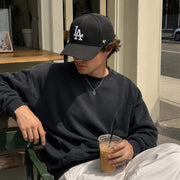 Man wearing ’47 Brand Los Angeles Dodgers black MVP adjustable hat with white LA logo