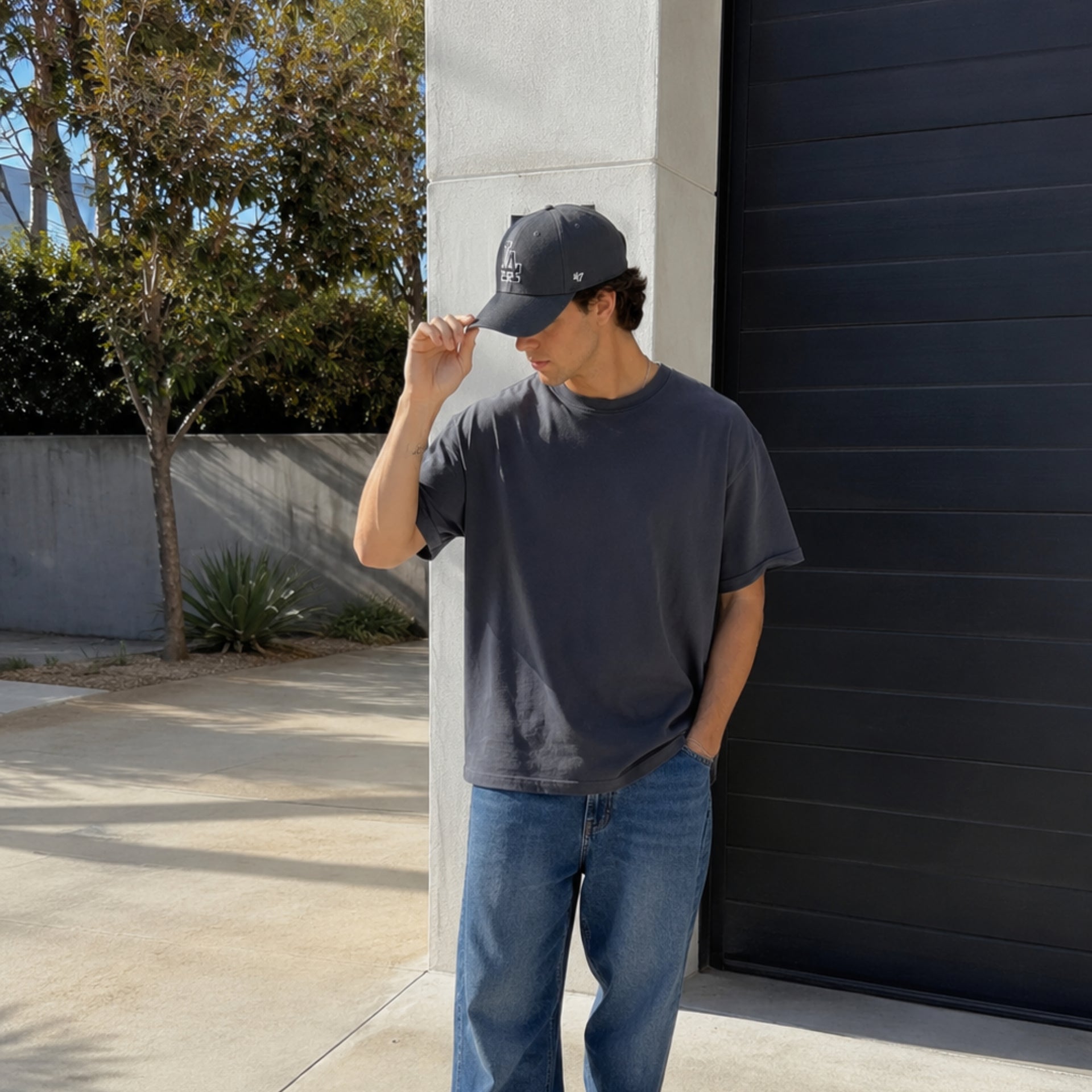 Man wearing ’47 Brand Los Angeles Dodgers charcoal MVP adjustable hat outdoors