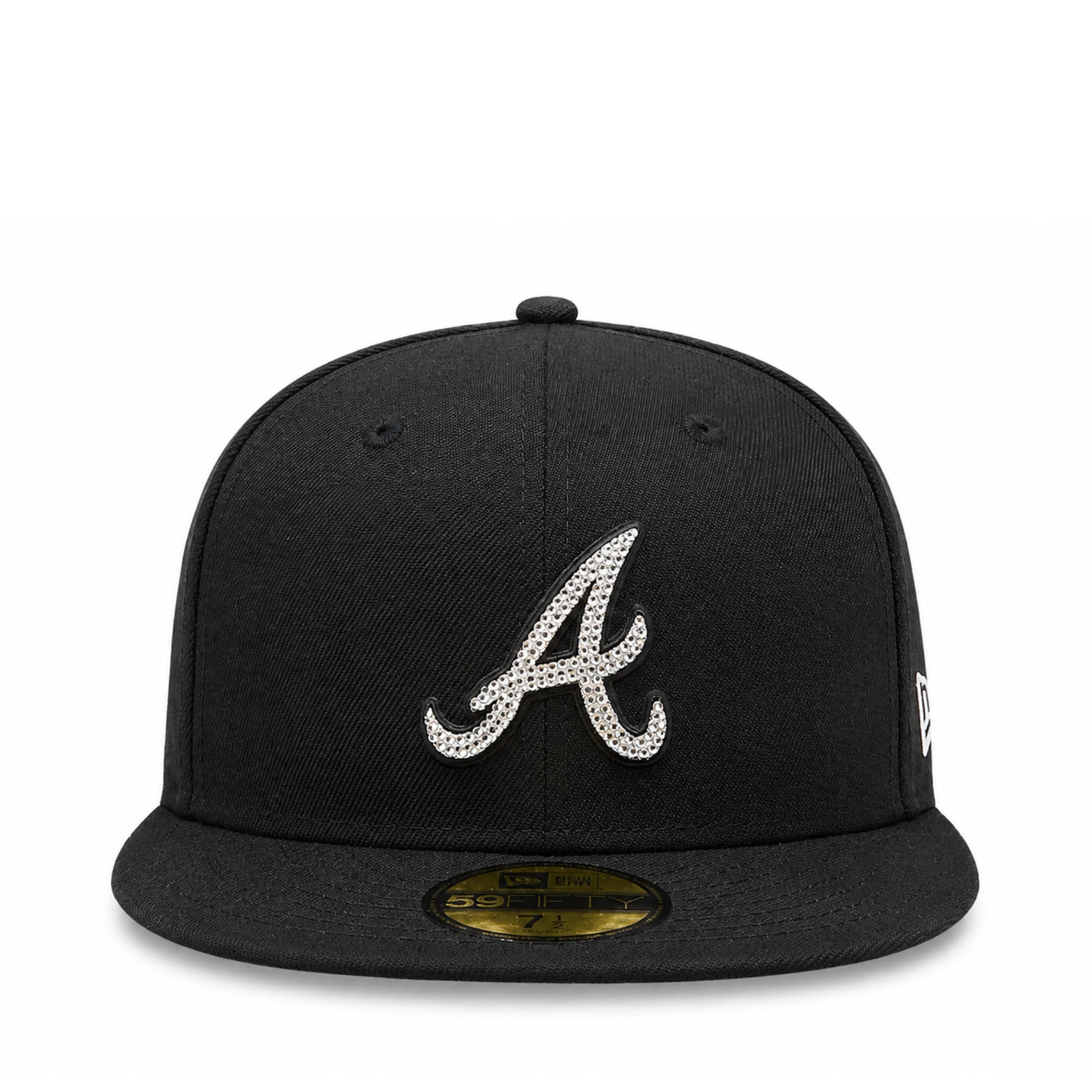 A black baseball cap featuring a silver rhinestone-embellished Atlanta Braves 'A' logo on the front, with a gold size sticker on the flat brim and a white New Era flag on the side.