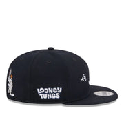 Black cap with 'Looney Tunes' logo on a white background