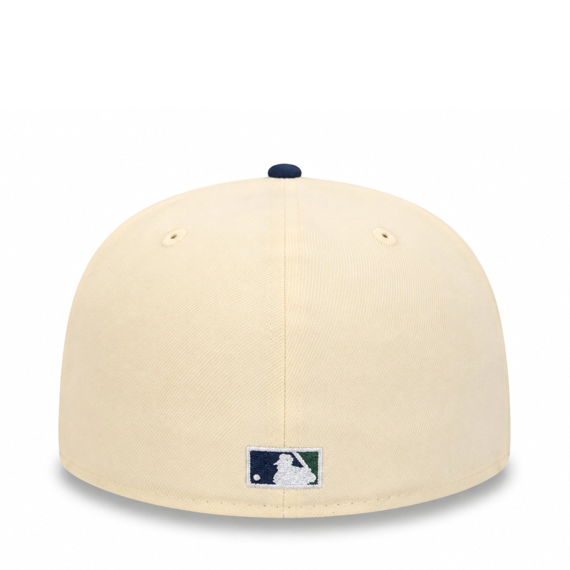 A cream-colored baseball cap with a navy blue button on top and a small MLB logo patch on the front, shown against a plain white background.