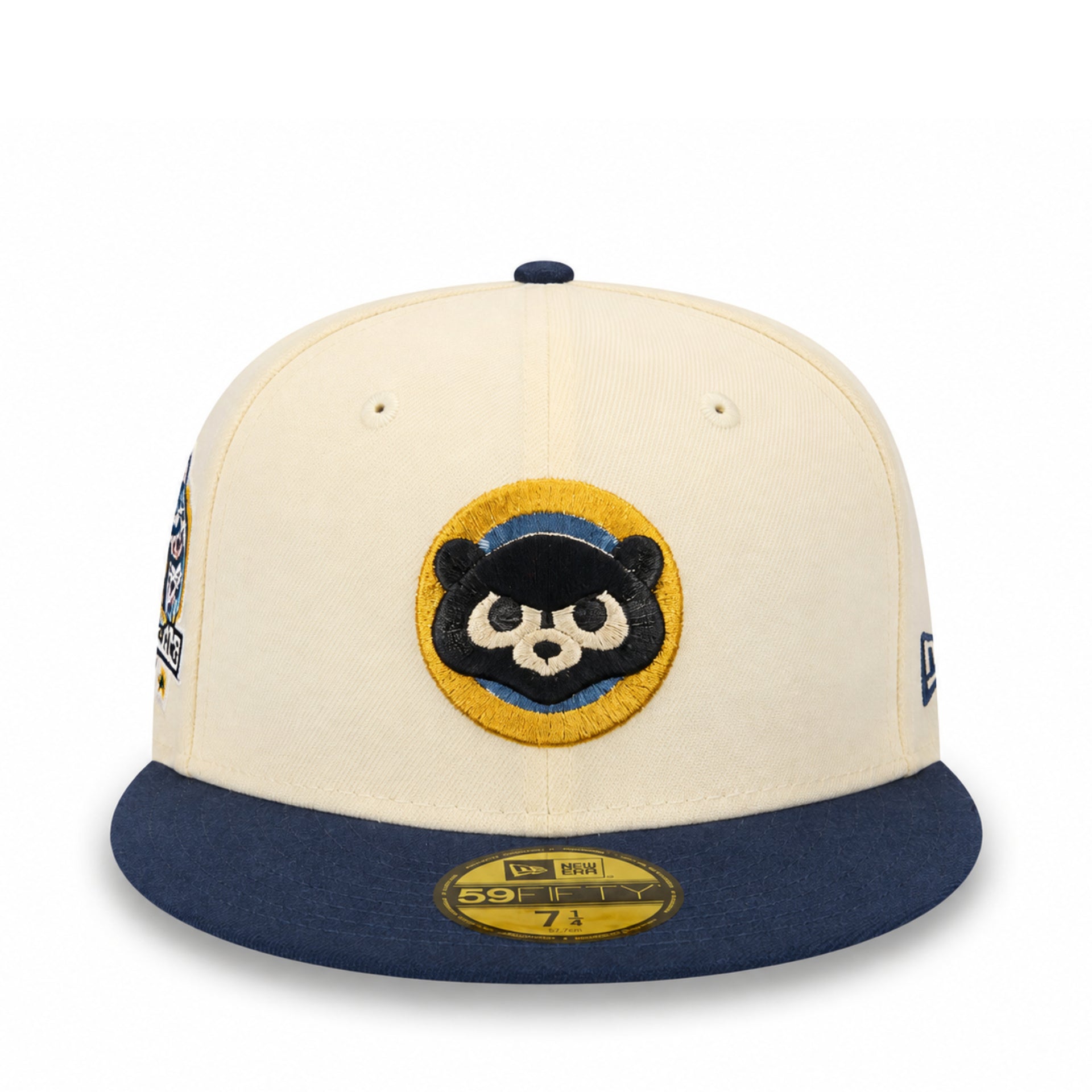 A cream and navy blue New Era 59FIFTY fitted cap featuring a custom embroidered panda patch on the front, displayed on a clean white background.