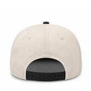 Beige cap with black interior and strap on a white background