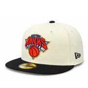 Angled view of New Era Knicks 2026 Champions Chrome Black 59FIFTY fitted cap featuring raised Knicks embroidery and New Era side logo