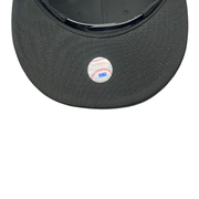 Black baseball cap with a baseball logo on the brim against a white background