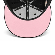 Underside view of New Era Los Angeles Angels 50th Anniversary 59FIFTY fitted hat showing the pink undervisor, black interior taping and Cooperstown Collection label