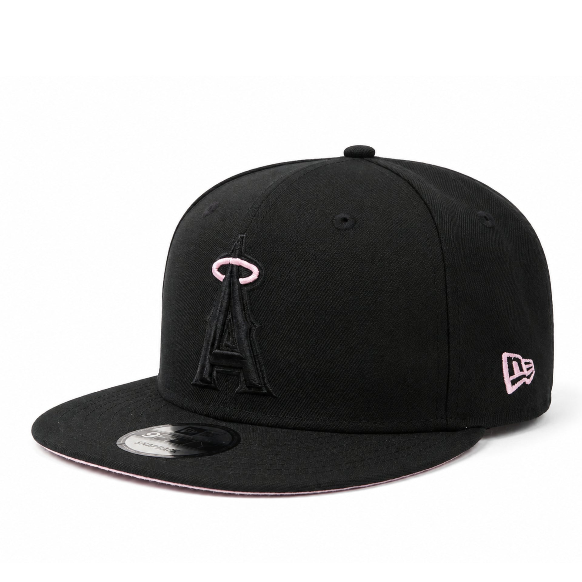 A black flat-brim baseball cap featuring a black embroidered Los Angeles Angels 'A' logo with a pink outline on the front, and a pink-outlined New Era flag logo on the side. The cap is photographed on a clean white background.
