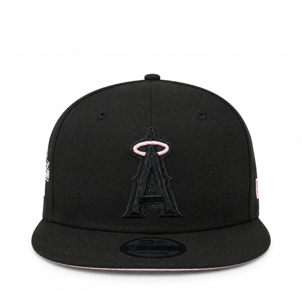 A black flat-brim baseball cap featuring an embroidered black Angels logo with a pink halo on the front, shown against a plain white background.