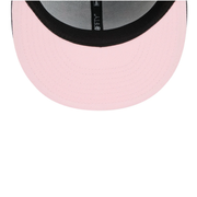 Close-up of a pink cap with a black rim on a white background
