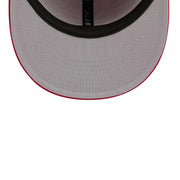 Close-up of a gray cap with red rim on a white background