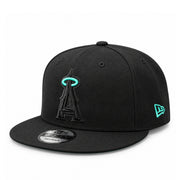 Angled front view of New Era Los Angeles Angels black snapback cap featuring a tonal black A logo with mint halo