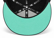 Underside view of Los Angeles Angels black New Era 9FIFTY snapback cap with mint green undervisor and interior taping