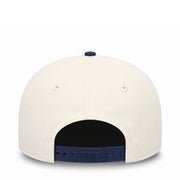 White cap with blue interior and brim on a white background