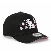 angled view of New Era Los Angeles Dodgers Cherry Blossom Black 9FORTY A-Frame Snapback with white LA logo, pink cherry blossom embroidery, and pink undervisor.