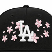 close view of New Era Los Angeles Dodgers Cherry Blossom Black 9FORTY A-Frame Snapback with white LA logo, pink cherry blossom embroidery, and pink undervisor.