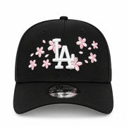front view of New Era Los Angeles Dodgers Cherry Blossom Black 9FORTY A-Frame Snapback with white LA logo, pink cherry blossom embroidery, and pink undervisor.