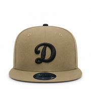 Beige cap with black ldodgers d logo on a white background