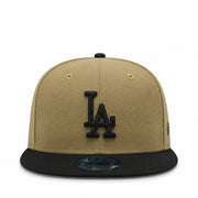 Beige and black baseball cap with LA logo on a white background
