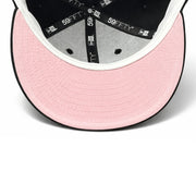 Underside of New Era Los Angeles Dodgers black 59FIFTY fitted hat showing the pink undervisor and interior New Era branded taping