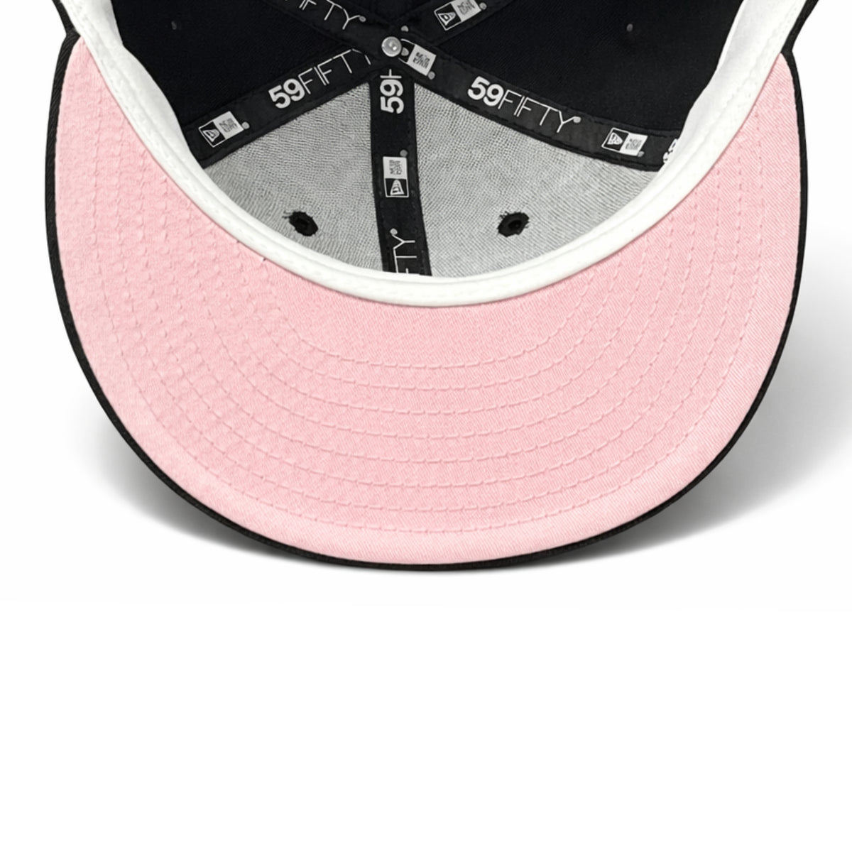 Underside of New Era Los Angeles Dodgers black 59FIFTY fitted hat showing the pink undervisor and interior New Era branded taping