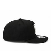 Black cap with a brand logo on the side against a white background