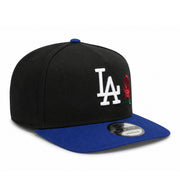 angled view of New Era Los Angeles Dodgers Rose 9FIFTY A-Frame Snapback Hat in black and royal blue with embroidered LA logo and red rose detail.