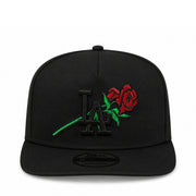 Black cap with LA logo and red rose on a white background