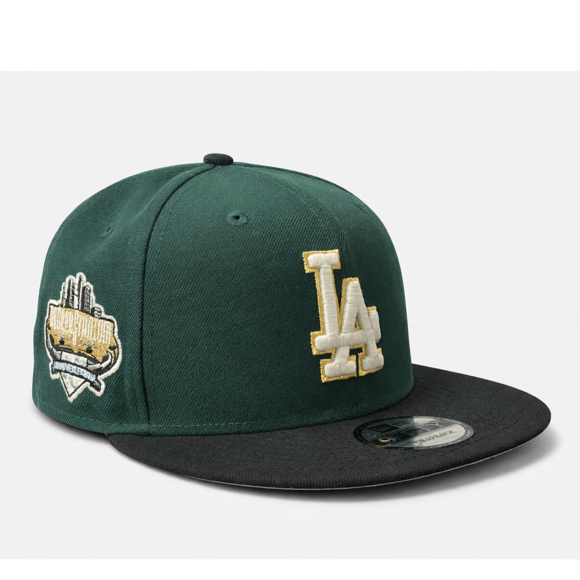 Green and black baseball cap with 'LA' logo on a white background