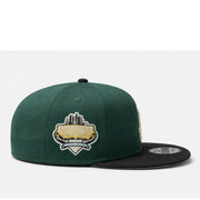 side view of Green and black baseball cap with 'LA' logo on a white background