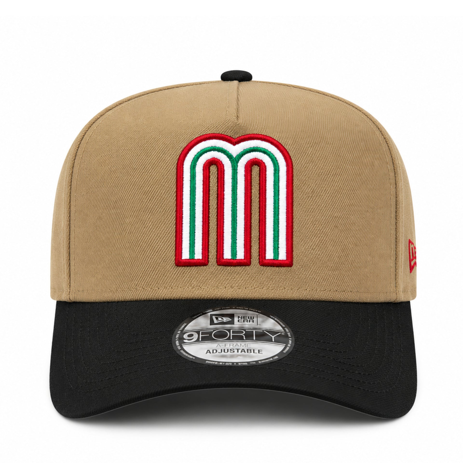 A New Era 9Forty adjustable baseball cap in tan and black, featuring a large embroidered letter 'M' patch on the front in red, white, and green.