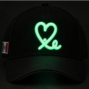 New Era Mexico Heart black 9FORTY A-Frame hat showing glowing green heart embroidery in the dark