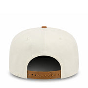 White cap with brown leather strap on a white background