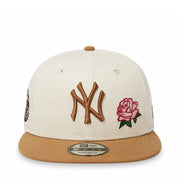 Baseball cap with embroidered logo and rose design on a white background
