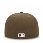 A structured brown baseball cap with a white embroidered MLB logo patch on the front, shown against a plain white background.