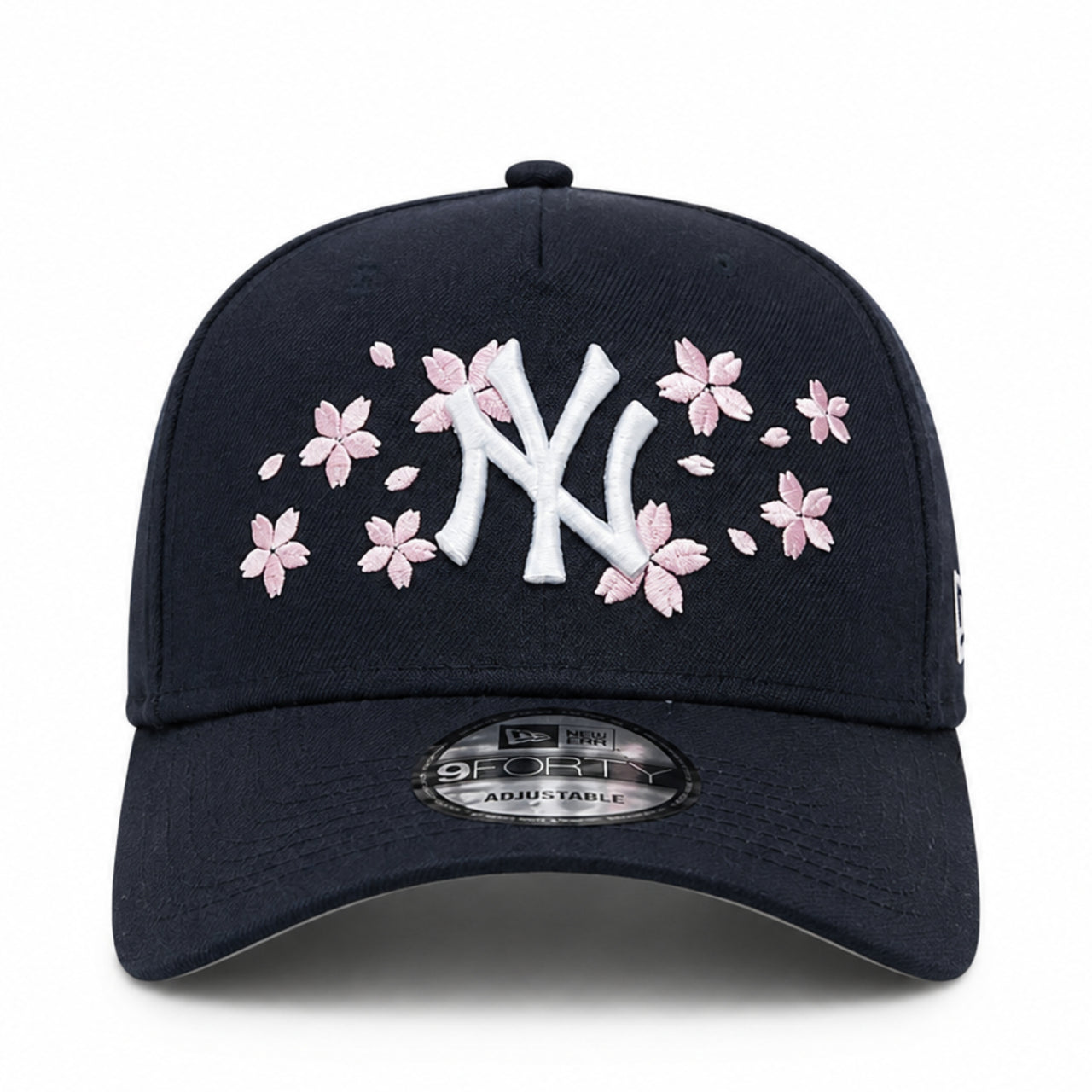 Navy blue New York Yankees NY cap with white logo and pink floral designs on a white background